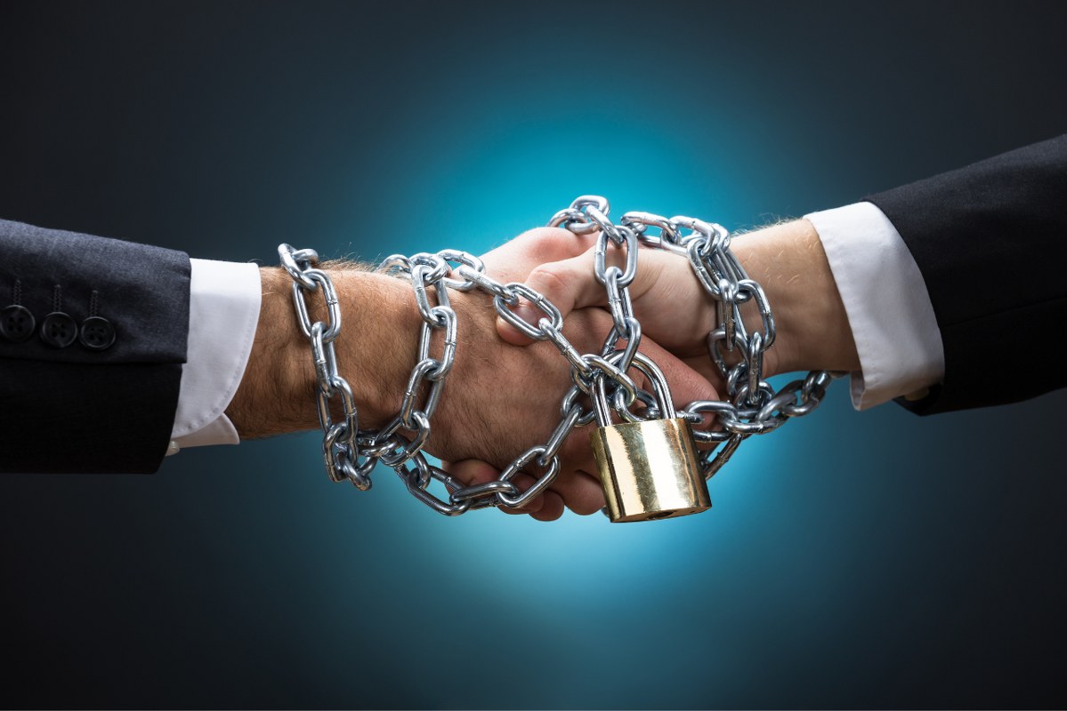 Chained Businessmen Shaking Hands assuring each other.