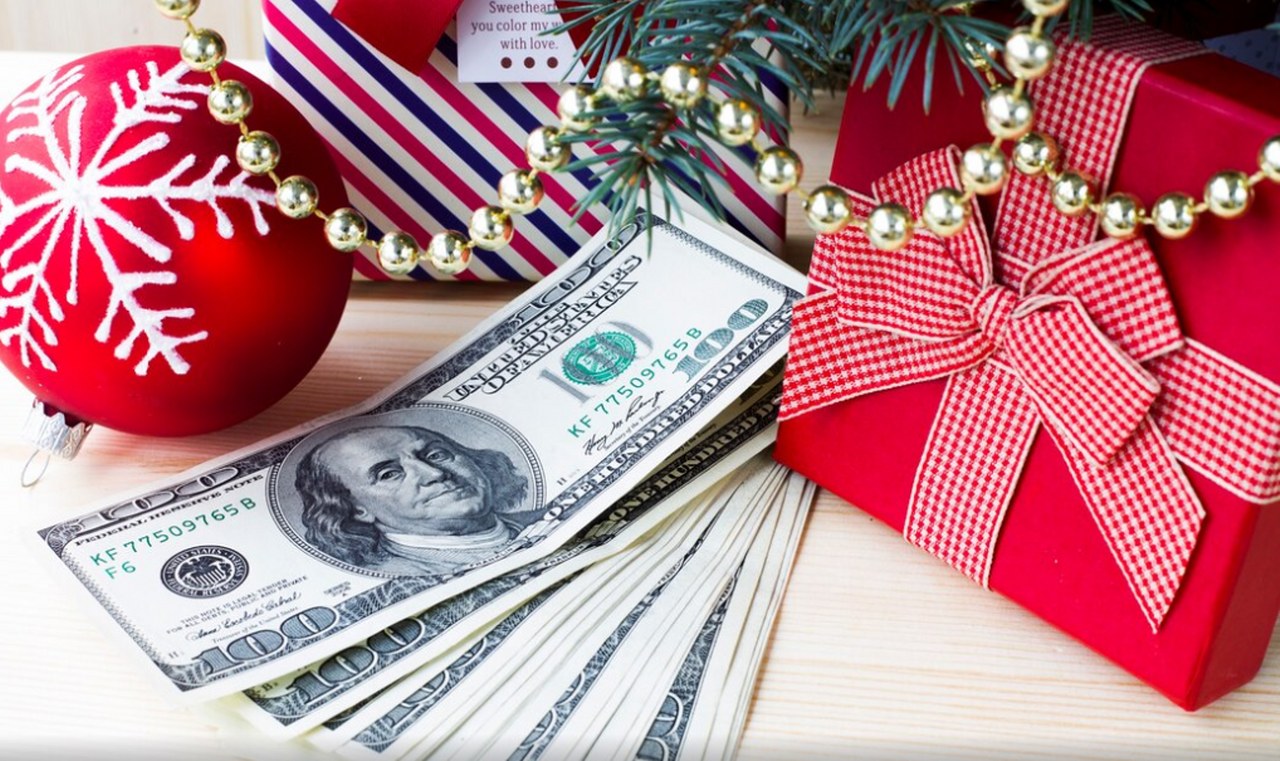 Christmas gifts next to money.