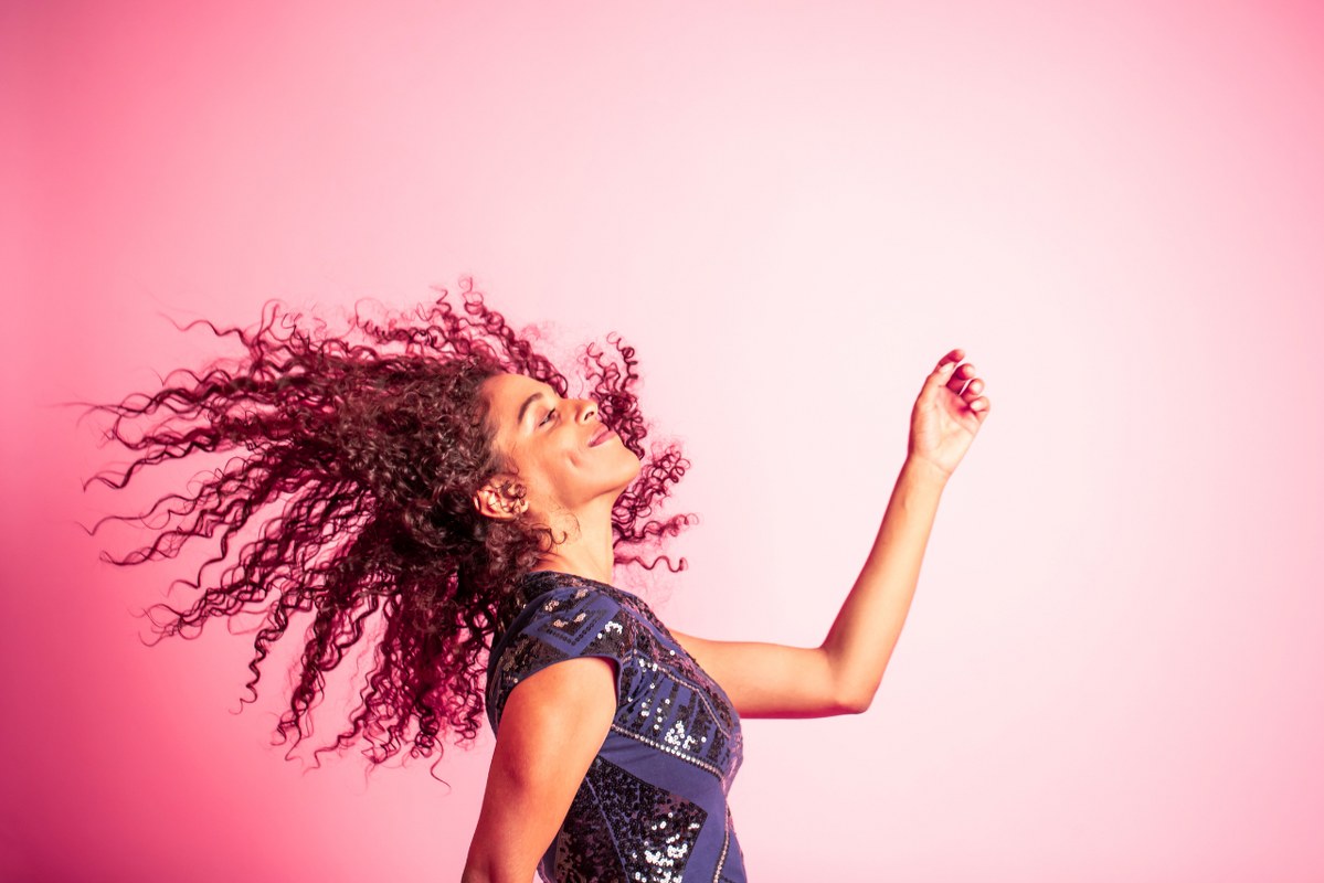 Curly woman dancing.