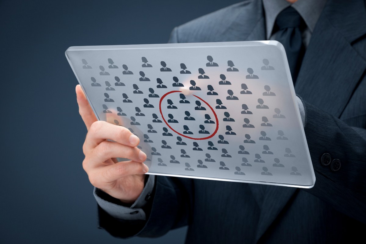 Customer segmentation concept: busienssman holds transparent tablet.