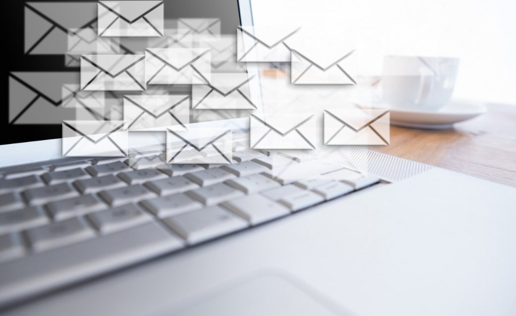 Envelopes hovering over a laptop.