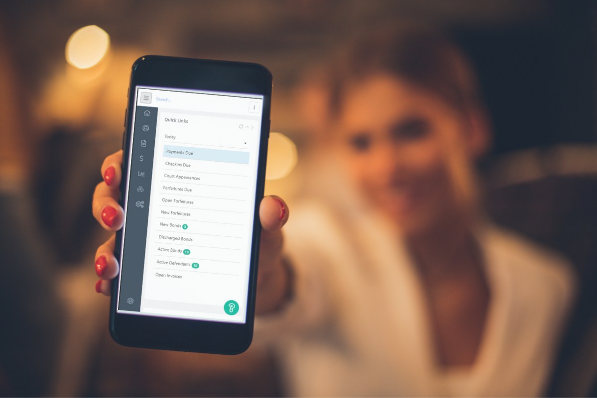 Female professional showing phone with bail bondsman software.