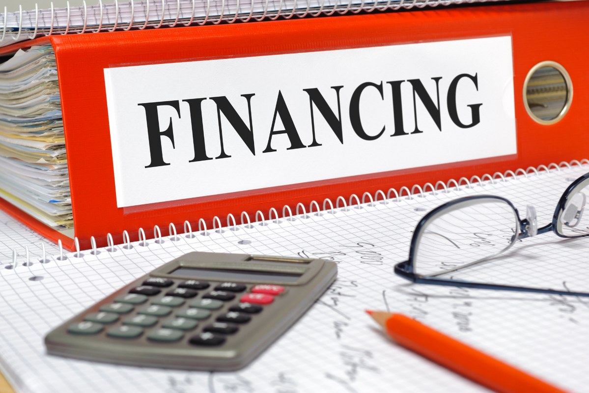 Financing red folder on table.
