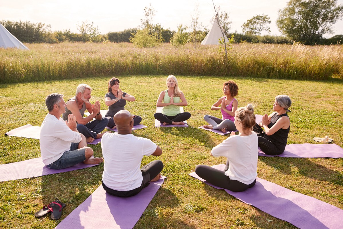Group of Mature Men and Women in Class at Outdoor Retreat.