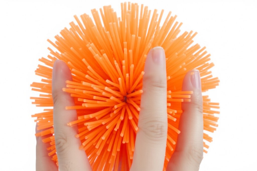 Hand holding koosh ball.