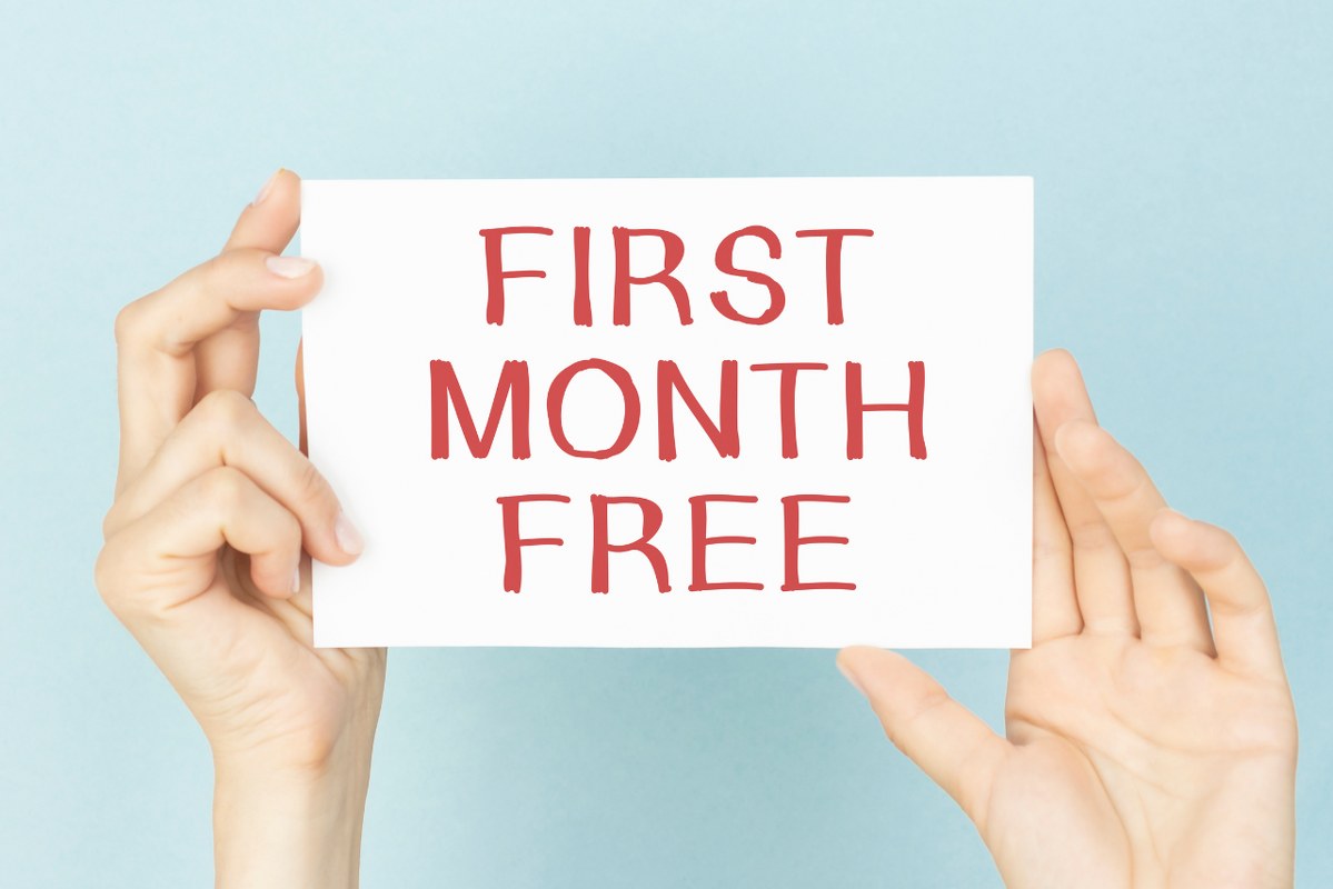 Hands hold card with First month free text.
