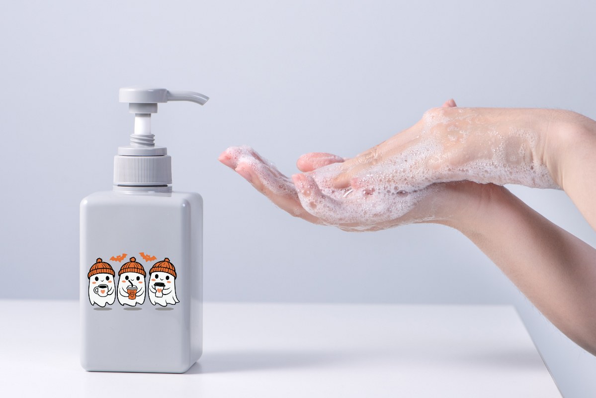 Hands washing with halloween-themed hand liquid soap.