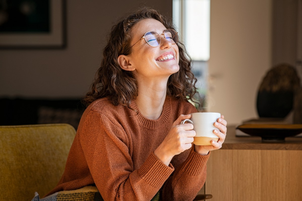 Happy Woman Enjoying Coffee at Home because of freebie.