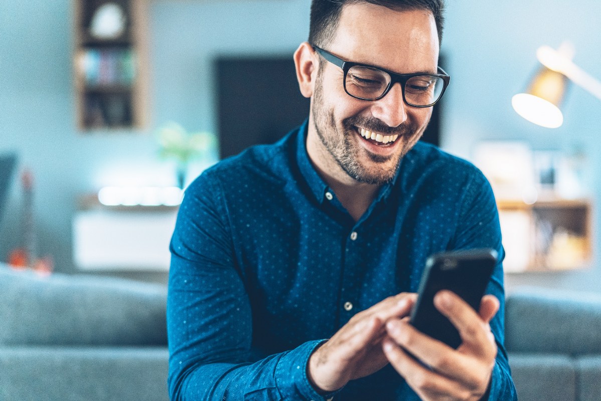 Male person super engaged on his phone.