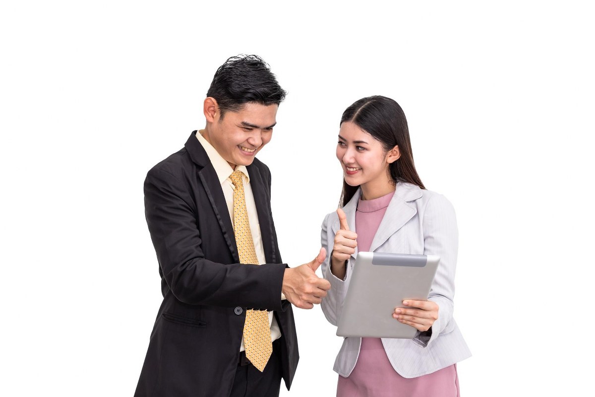 Man and woman are giving a thumbs up.