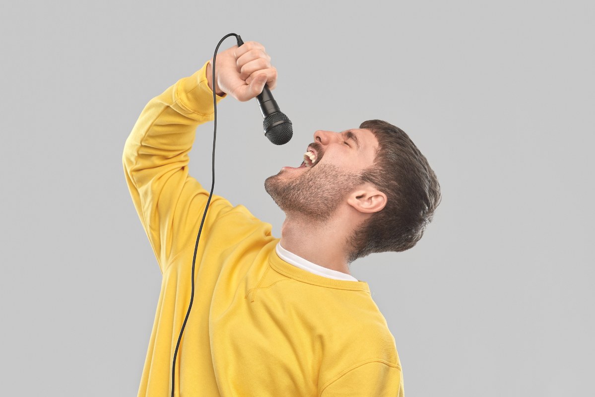 Man shouting on microphone.