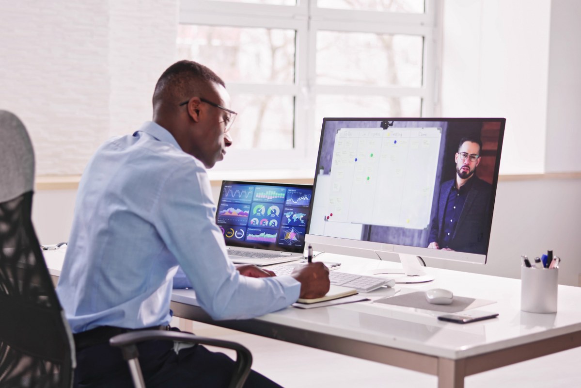 Man taking notes from Video Training.