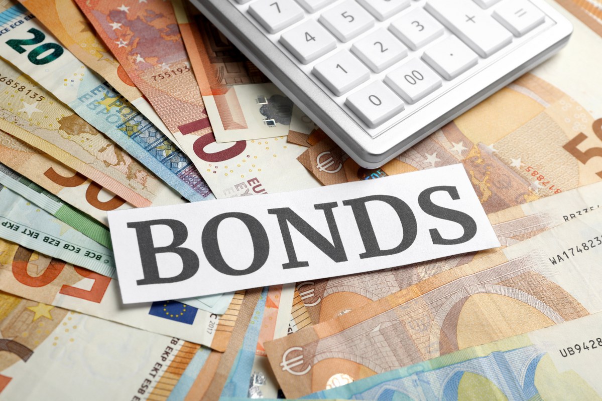 Many Euro Banknotes and Paper with Word Bonds as Background.