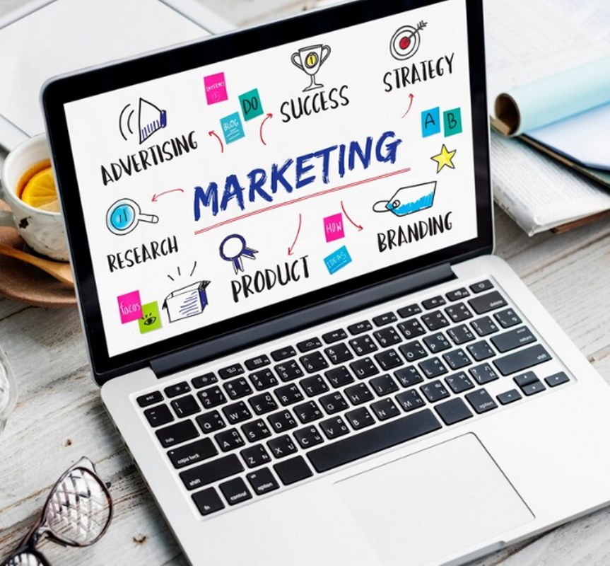 Marketing-related icons displayed on a laptop.
