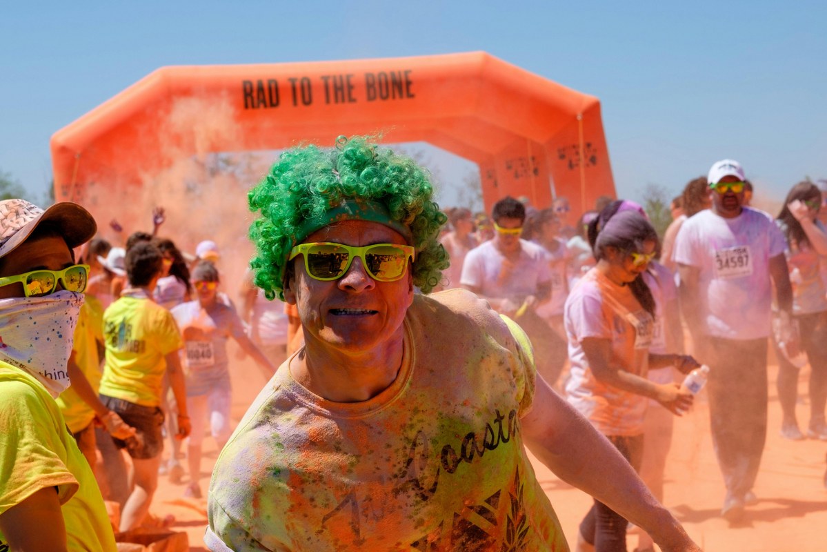 People Covered in Colorful Powder on a Color run.