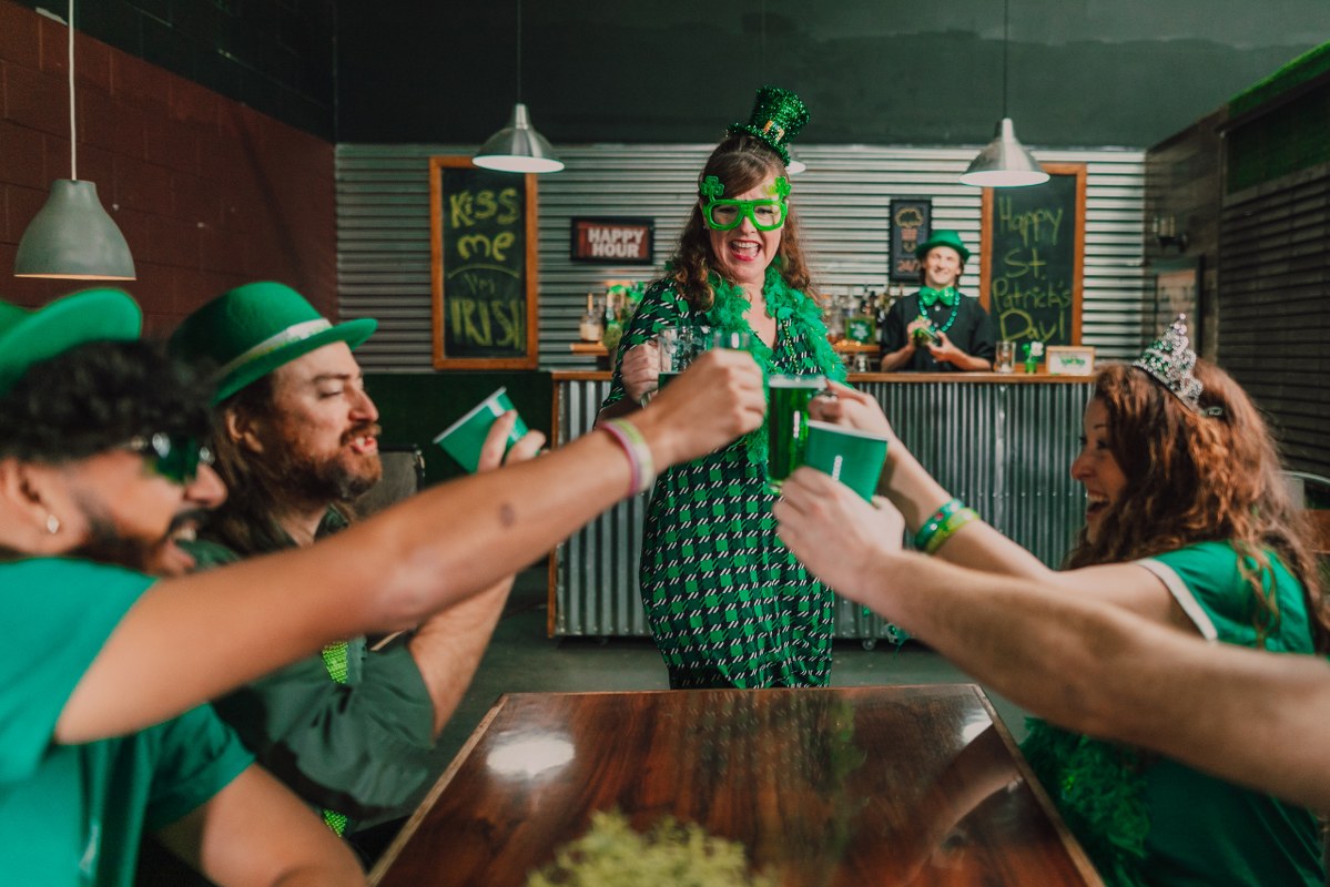 People in Green Outfit Celebrating St. Patrick's Day in a bar.