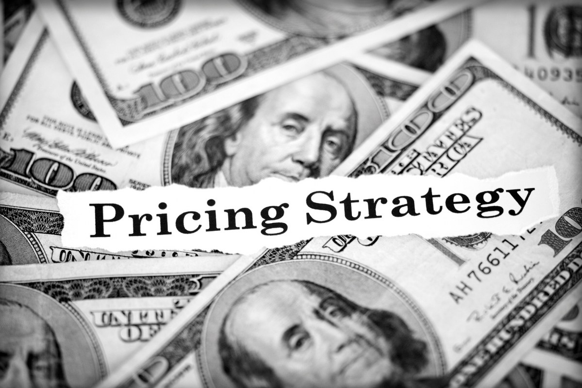 Pricing strategy text on 100 dollar bills.
