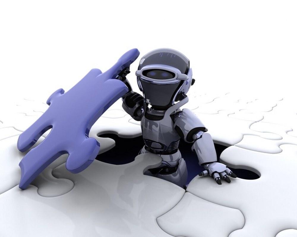 Robot with the final piece of the jigsaw puzzle.
