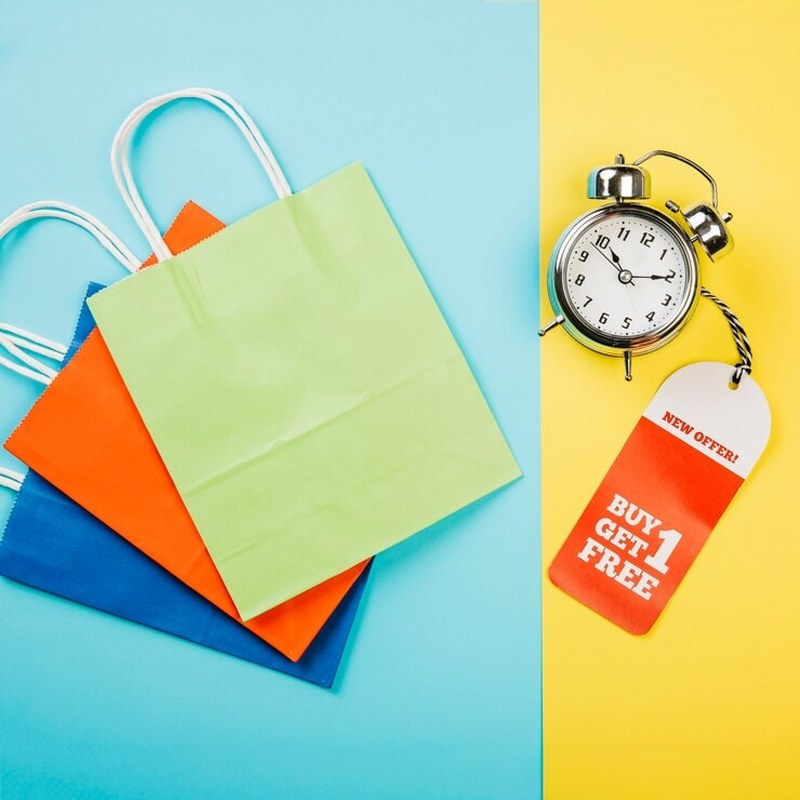 Sales concept with alarm clock and label.
