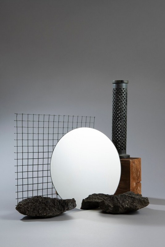 Stones are lined up in front of the glass.
