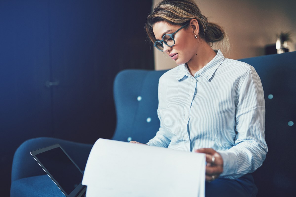 Woman focused on reading document.