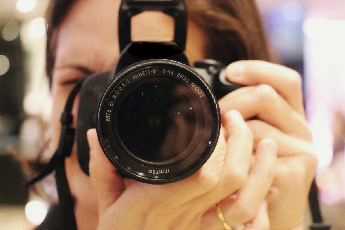 Woman taking a photograph.
