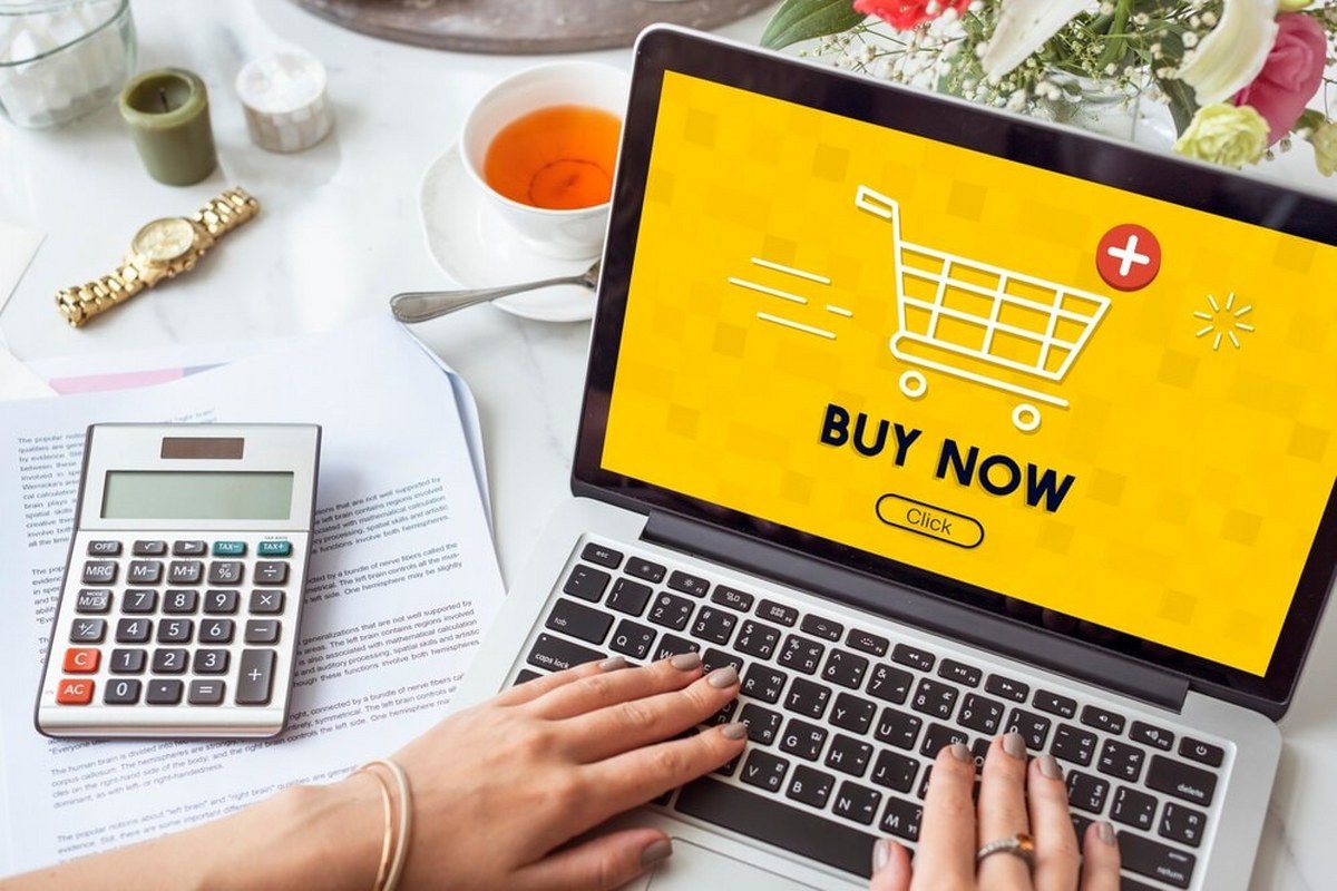 Woman using laptop for online shopping.