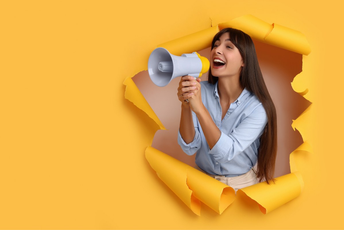 Woman with Megaphone Shouting through Hole.