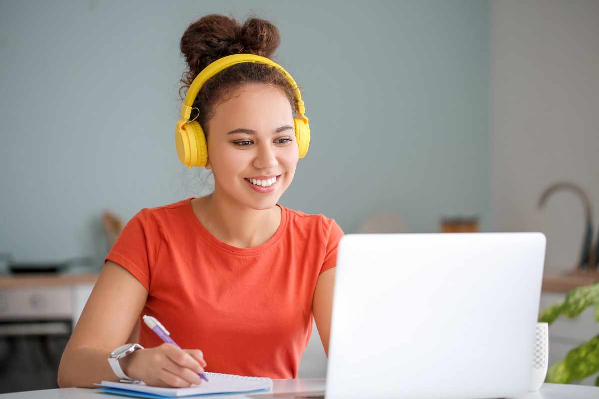 Young Woman Using Laptop for Online Learning at Home.