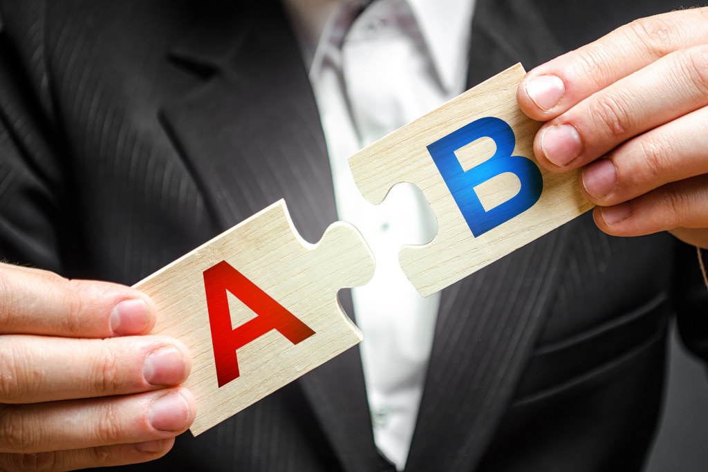 A man connects puzzles with the letters A and B.