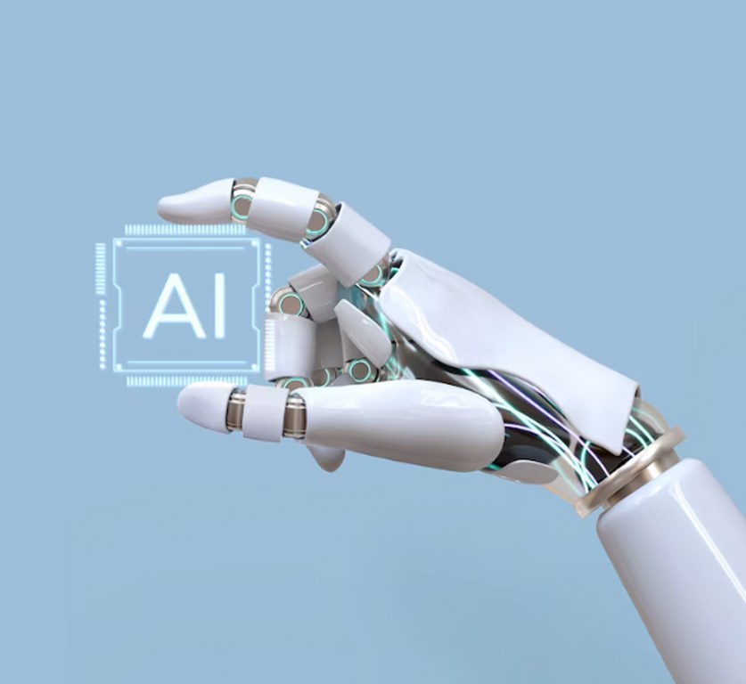 A robotic hand holding a chip written AI.