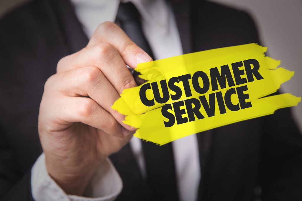 Businessman highlighting Customer Service word.