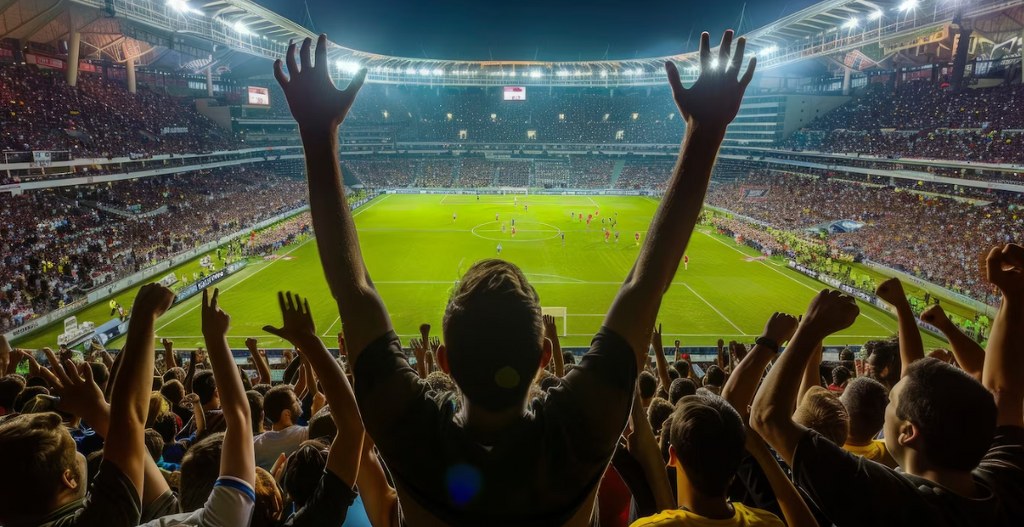 Fans in a stadium during a soccer game.