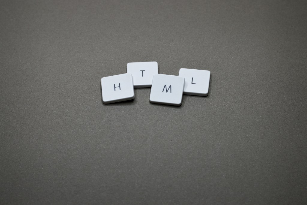 Four Letter Tiles forming HTML.