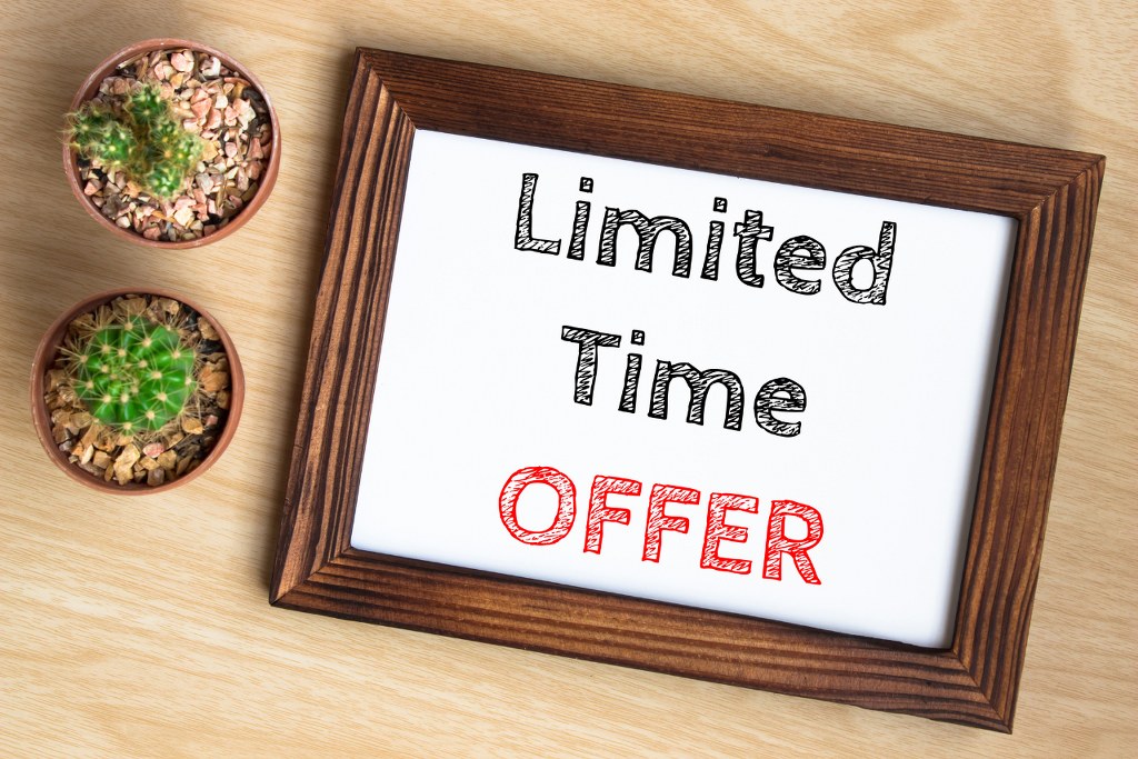 Limited time offer, text message on wood frame board on wood table.