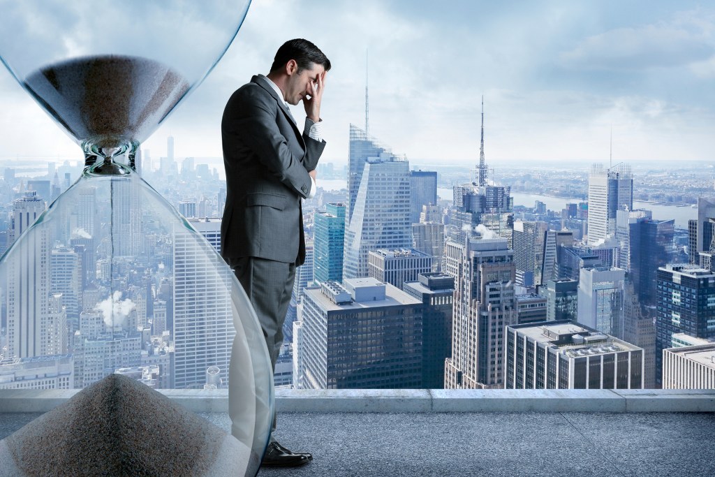 Stressed businessman running out of time.