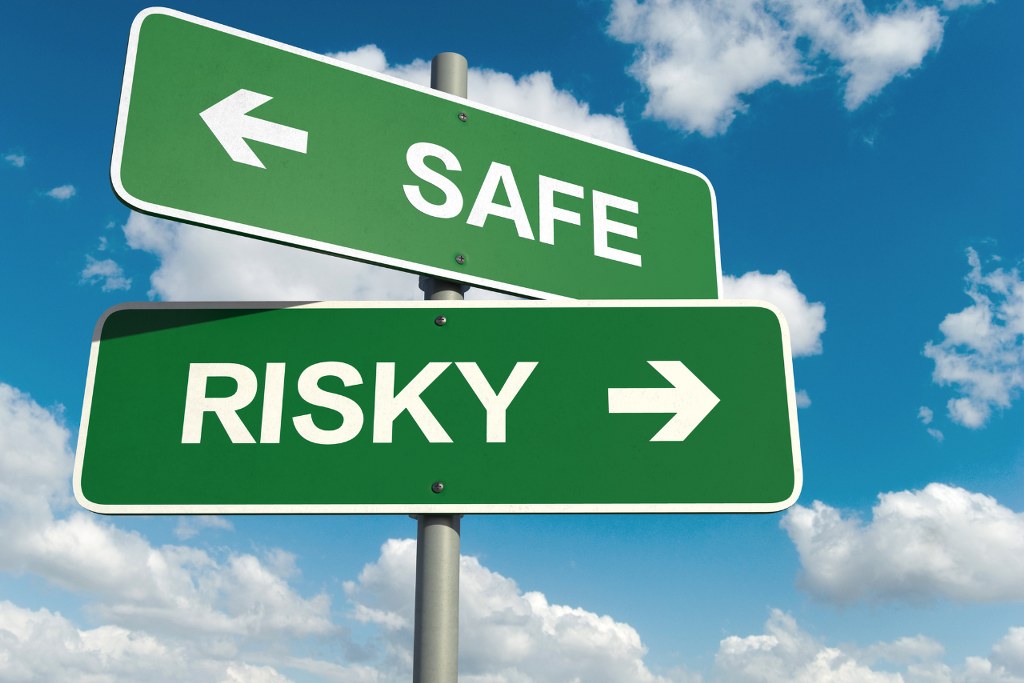 Two road signs saying safe and risky.