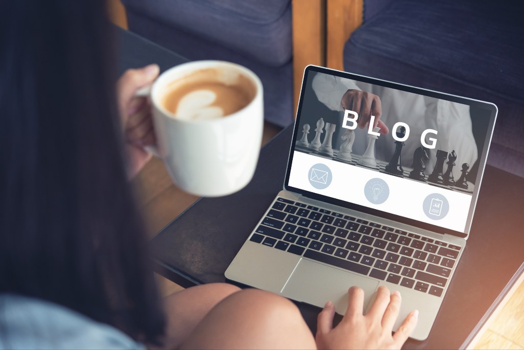 Woman creating blog on her laptop.