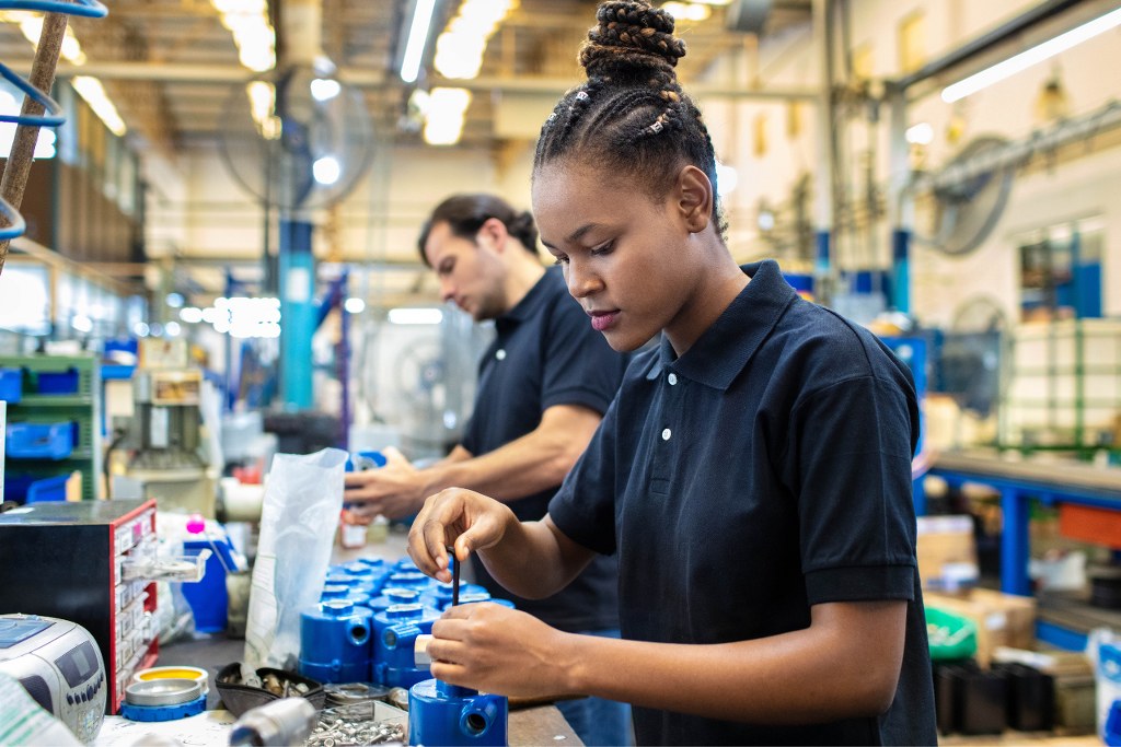 Worker assembling products in manufacturing company.