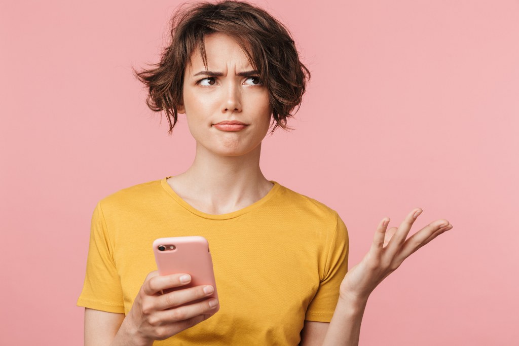 Confused Woman Using Smartphone.