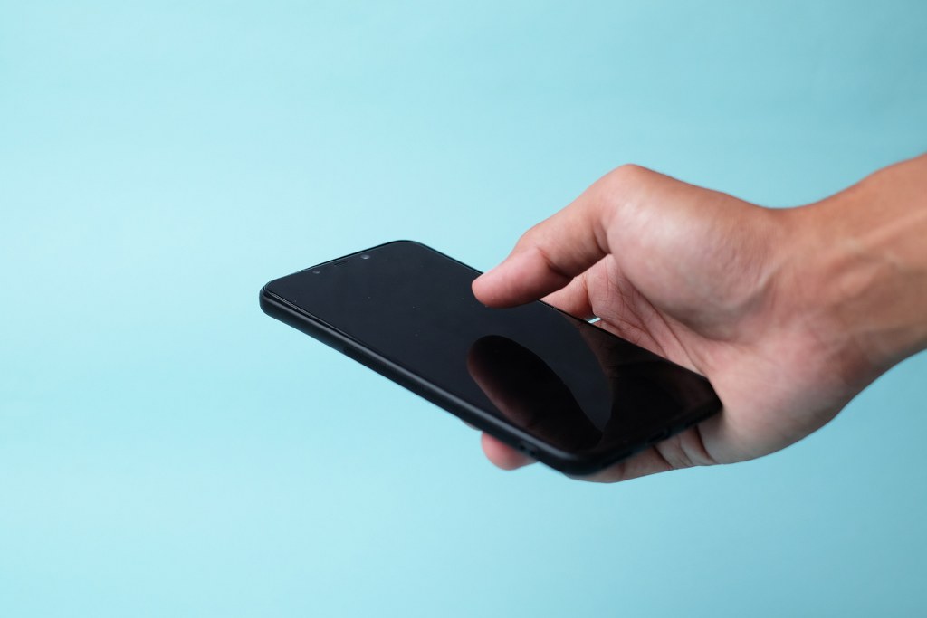 Holding phone.