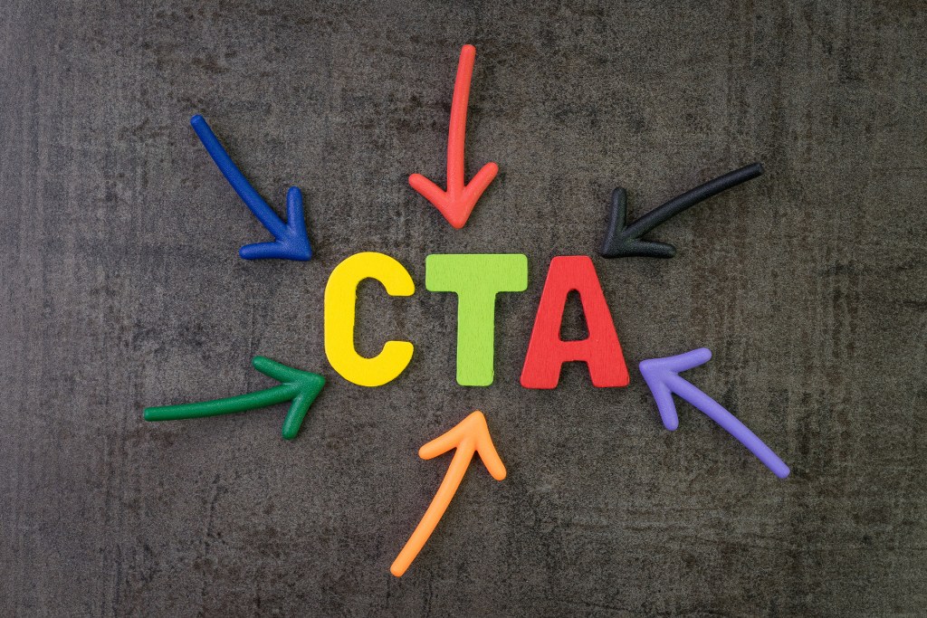 Multi color arrows pointing to the word CTA at the center of black wall.