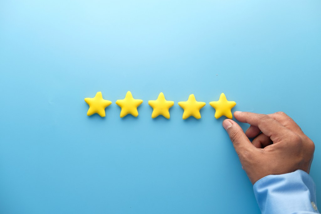 Rating Golden Stars on Blue Background.