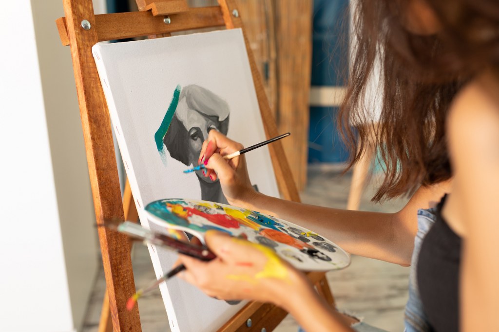 Woman painting portrait.