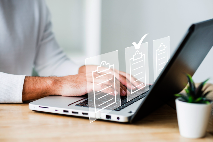 Person typing on a laptop with digital clipboard icons and checkmarks overlaid, symbolizing task management and productivity.