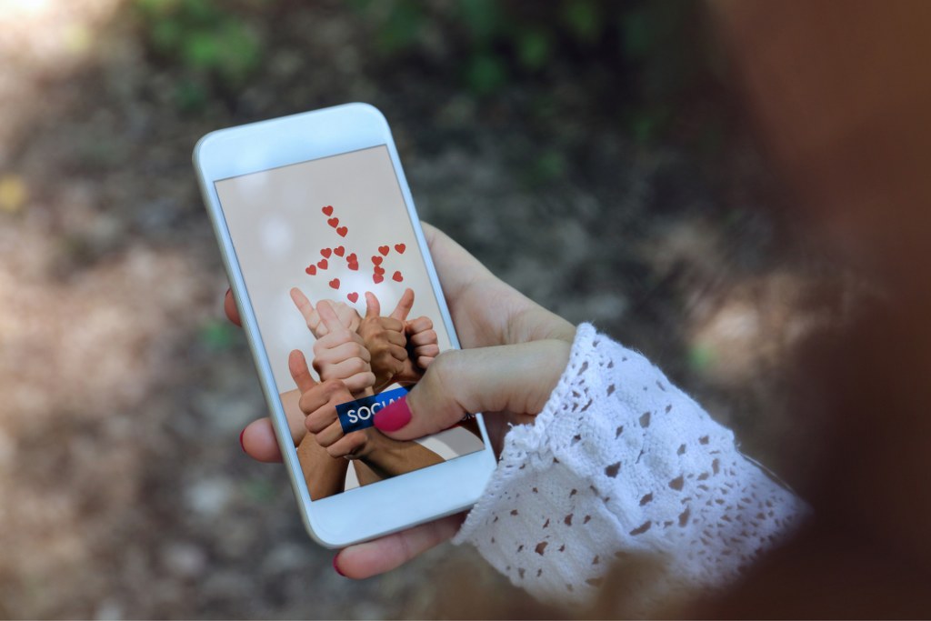 Finger hitting social media button.