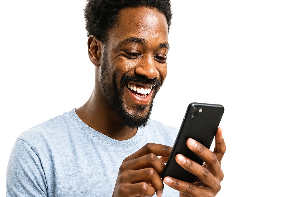 A man scrolling his phone.