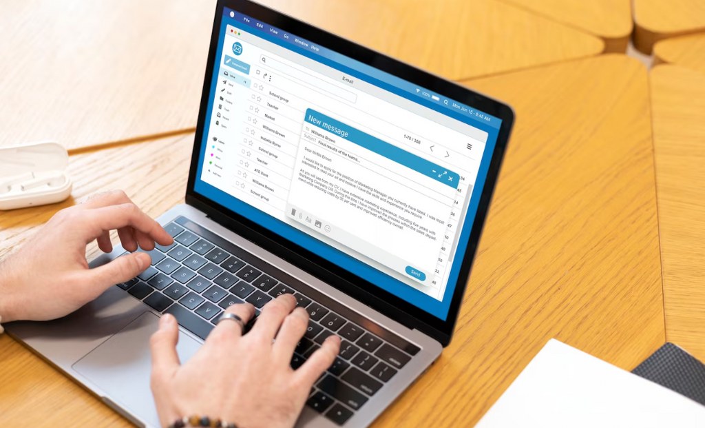 A person typing an email.