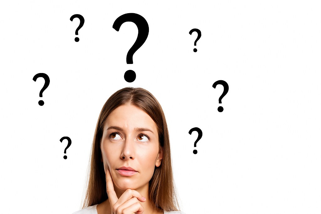 A woman thinking with question marks floating over her head.