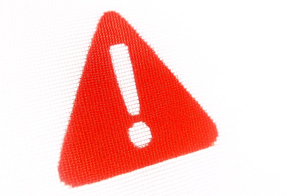 An exclamation mark inside a triangle.